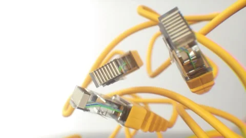 Floating Yellow Ethernet Cables With Clear RJ-45 Connectors on White Background Stock Footage 309559521