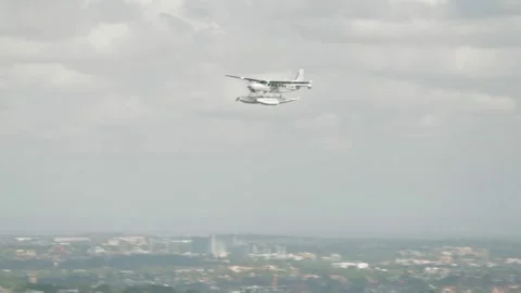 Floatplane in Flight Above Sydney Suburbs with Urban Landscape and Cloudy Sky Stock Footage 345730694