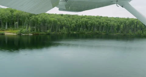 Floatplane landing on the lake in Alaska. View from the inside of the aircraft Stock Footage 317868969