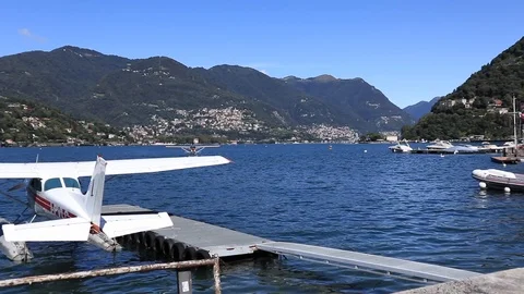 Floatplane landing on lake Como in Italy  during a sunny day Stock Footage 115675508