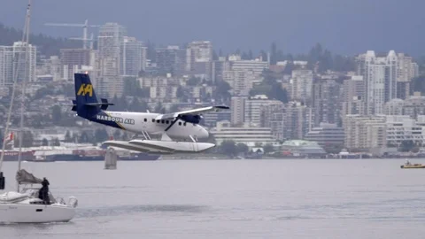 Floatplane making water landing in Vancouver bay, city and harbour Stock Footage 119464135