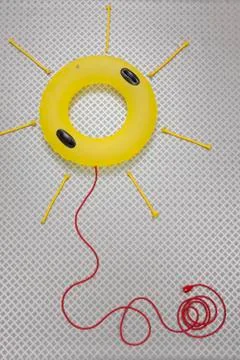 Floats forming sun shape connected with electric cable Fotos Stock