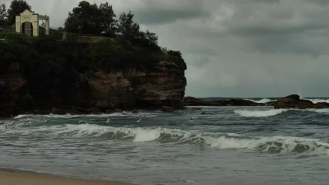 A flock of seagulls pass Coogee Dolphin Point slow motion 4K Video stock 272197432