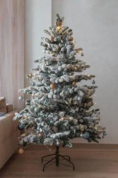 Flocked Christmas tree decorating for winter holiday season Stock Photos