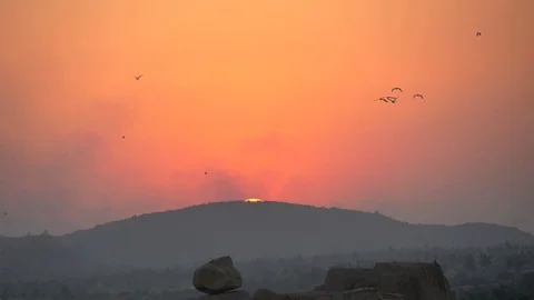 Flocks of birds slowly fly against the background of sunset or dawn 库存影片 121001337