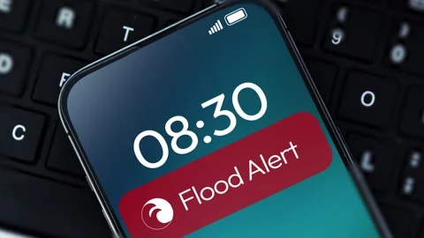 Flood Alert notification appearing on the smartphone screen close up, 4k footage Stock Footage 313344087