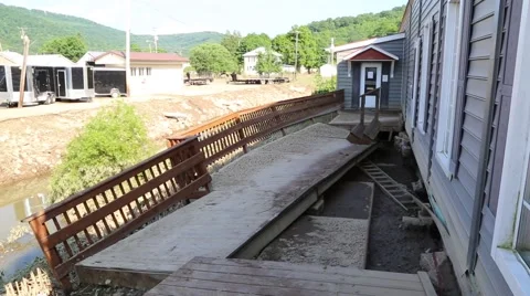Flood Damaged Deck of House Falling Into River  Video stock 64936288