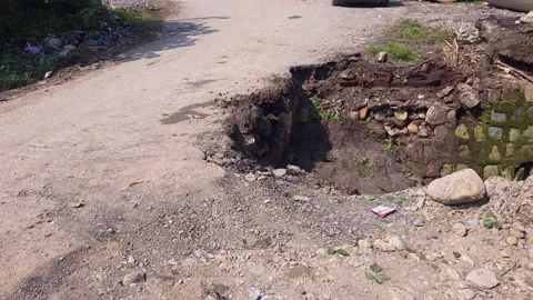 Flood erosion causing road break in India Stock Footage 321039604