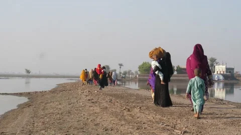 Flood Victims Walking Along Path To Relief Camp In Sindh, Pakistan. Slow Stock Footage 237449845