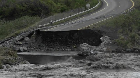 A flood washes away a highway. 库存影片 24948874