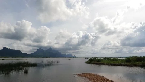 Flood water area reflect cloudy over sky with beautiful mountain landscape Stock Footage 221214644