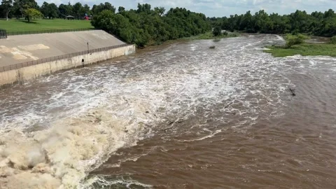 Flood water flows downstream after released from the Lake Overholser Dam Stock Footage 313810010