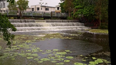 Flood water flows over a three tier weir in a canal. Stock Footage 297847595