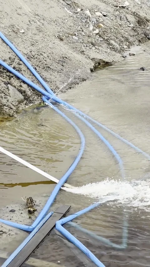 Flood water pumping down the leaking hoses outdoors, vertical Stock-Footage 247322881
