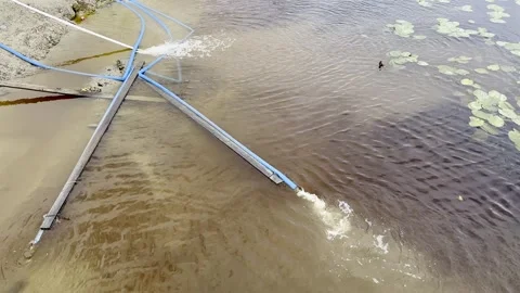 Flood water pumping down the leaking hoses outdoors Stock Footage 247323038