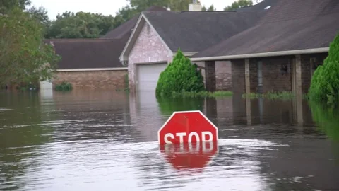 Flood water reaches the level of a street sign during hurricane Harvey Stock Footage