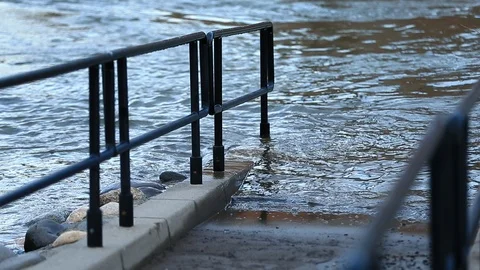 Flood Waters Overtake Walkway with Railing - Shallow Depth of Field Stock Footage 103122604