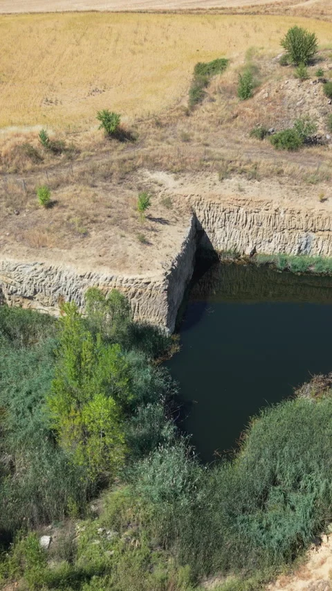 Flooded ancient stone quarry in the dry Spanish countryside Stock Footage 340996872