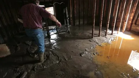 Flooded basement man walks through thick mud P HD 1919 Stock Footage 11496594
