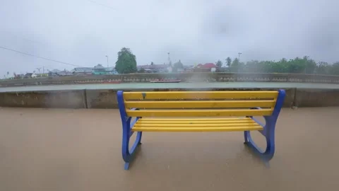 Flooded Bench by the River on Rainy Day Stock Footage 311987122