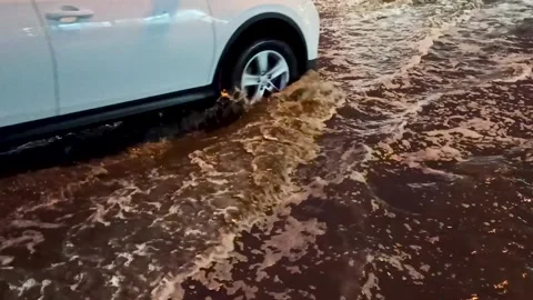 Flooded city road with large puddle. Flooding after heavy rains at city Vídeos de archivo 220445628