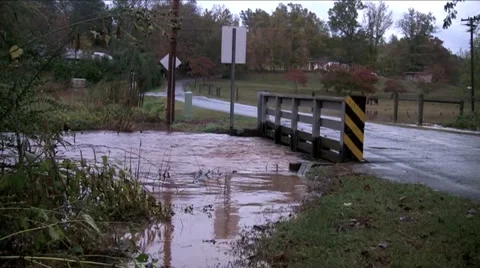 Flooded creek with bridge Stock Footage 904826