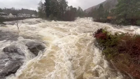Flooded Falls of Dochart at Killin as weather warnings cover most of Scotland Stock Footage 296642866