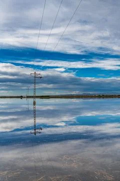 Flooded fields after the storm with power towers Foto stock