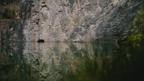 Flooded Former Slate Quarry With Dramatic Rock Face Reflection Stock Footage 346475956