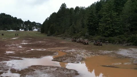 Flooded meadow with muddy water reflections and waiting off road vehicles Stock Footage 344096739