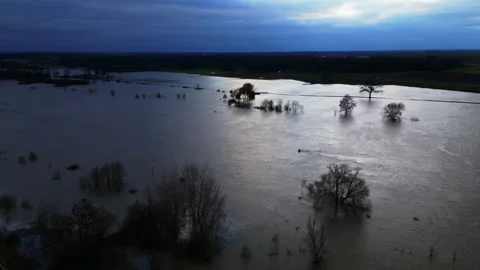 Flooded Meuse river in foreboding dark backlight revealing climate crisis 動画素材 261669099