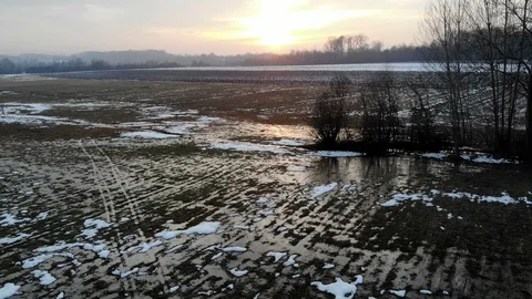 Flooded muddy grass field and melting snow. Aerial view. Stock Footage 101753316
