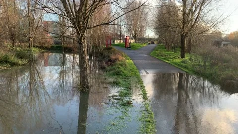 Flooded path and bench at Queen Elizabeth Olympic Park Stock Footage 145318520