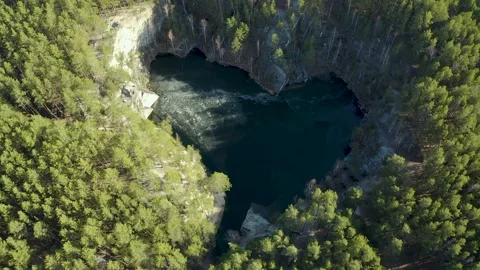 Flooded quarry in shape of a heart surrounded by forest, talcov stone, Ural Video stock 165317794