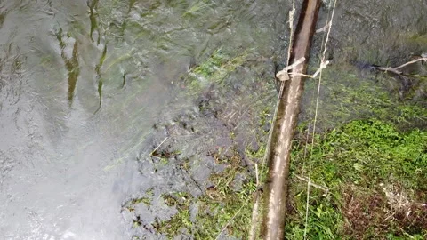 Flooded river crossing between jungle villages Video stock 132382810