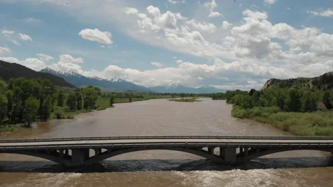 Flooded river nearly over the top of bridge Stock Footage 166329826