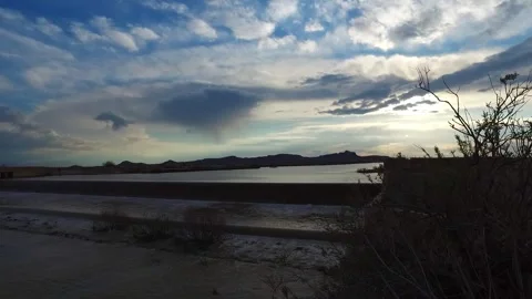 The flooded river set against a partly cloudy sky, stock footage. Stock Footage 304784353