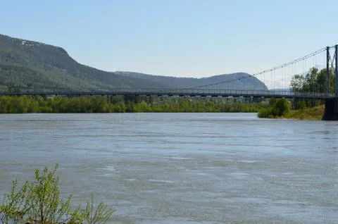 Flooded river in spring underneath bridge Stock Photos
