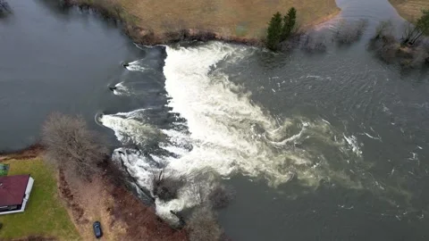 Flooded river with strong current at Skulestadmo Voss Norway extreme water flow Stock Footage 333489569