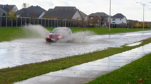 Flooded road driver goes fast and splashes another car Nov 12 2017 Ottawa ON Stock Footage 90610574