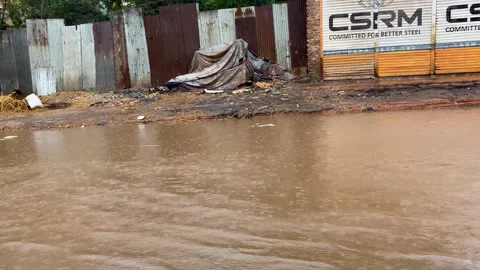 Flooded Road by Shuttered Shops in Dhaka, Bangladesh Stockbeeldmateriaal 345294892