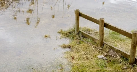 Flooded shoreline in the spring floods isolated with a wooden fence Stock Footage 104808501