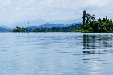 Flooded tree trunks and mountain view at Cheow Lan Lake in Khao Sok National Stock Photos