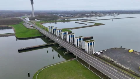 Floodgate System With Traffic, Gray Sky Above Protective Barrier With Marshland Stock Footage 325453030