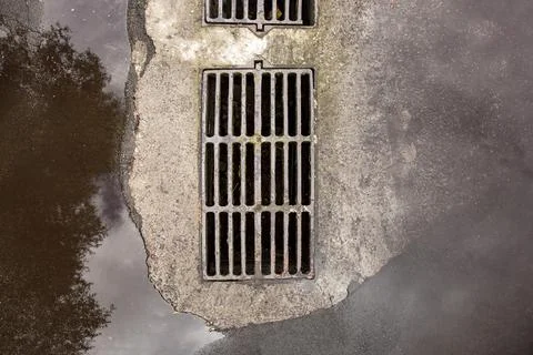 Flooding drainage system with a hatch grate for drainage of rainwater. Stock Photos