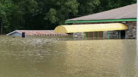 Flooding from record rainfall engulfs a store front Stock Footage 12576364
