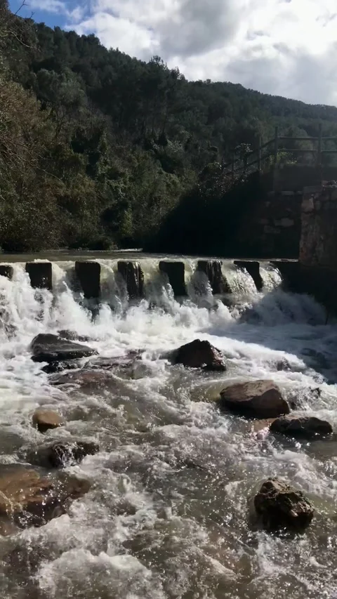 Flooding of a riverbed fed by water from recent torrential rains Stock-Footage 316594874