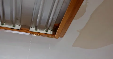 Flooding from second floor causing water to trip on light fixture from ceiling Stock Footage 161427384