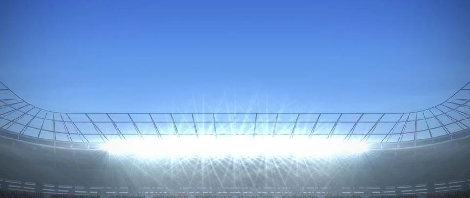 Floodlight array is illuminating curved stadium roof under clear sky in flat 写真素材