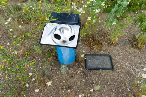 Floodlight for external lighting of the building. broken lantern fixed to the Stock Photos